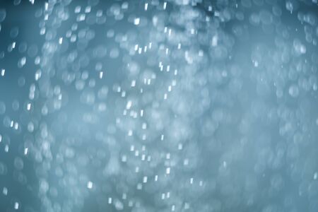 falling snow, abstract blue bokeh backgroundの写真素材