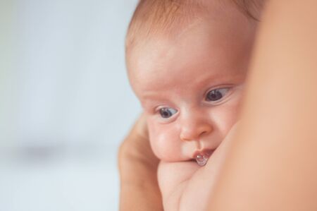 portrait of a child in the hands of momの写真素材
