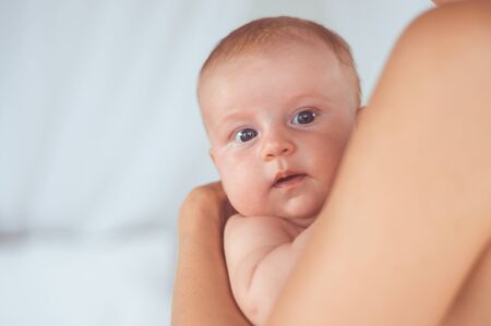 portrait of a child in the hands of momの写真素材