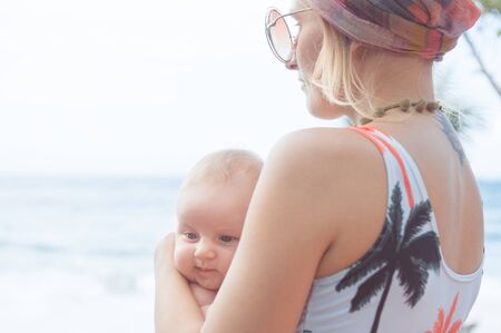 mother with baby on the beach