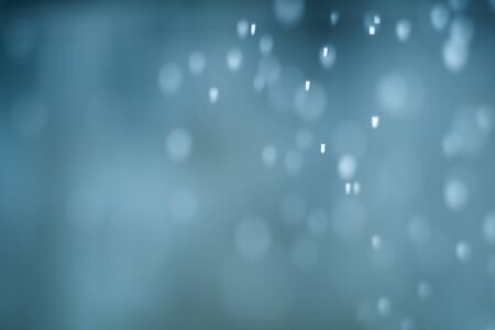 falling snow, abstract blue bokeh backgroundの写真素材