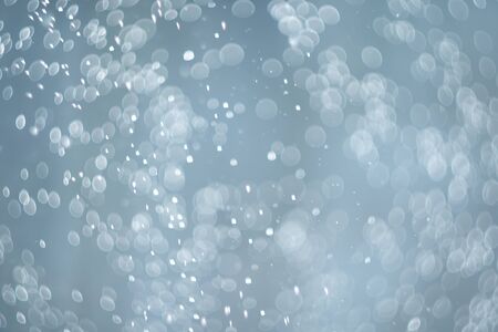 falling snow, abstract blue bokeh backgroundの写真素材