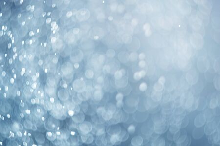 falling snow, abstract blue bokeh backgroundの写真素材
