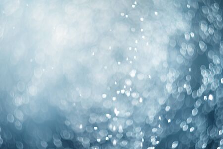falling snow, abstract blue bokeh backgroundの写真素材