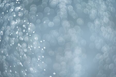 falling snow, abstract blue bokeh backgroundの写真素材