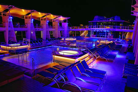 Cruise ship swimming pool at nightの写真素材