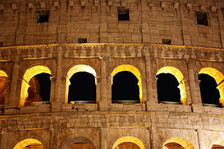 Famous coliseum of Rome at nightの写真素材