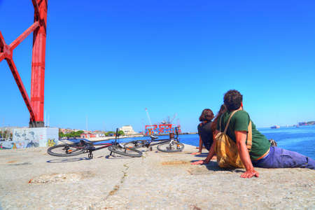 Tourists sitting under the famous bridge of 25 of Aprilのeditorial素材