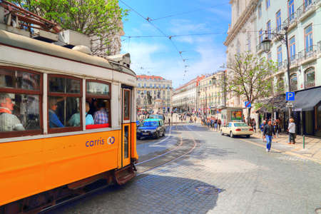 LISBON, PORTUGAL-OCTOBER 2017: Tourists sightseeing Lisbon on a famous yellow tramのeditorial素材