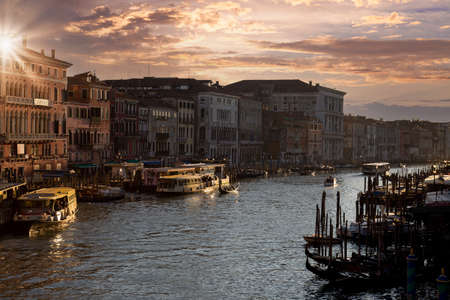 Venice Canals and gondolas near Rialto Bridge and Saint Marco square at sunset.の写真素材