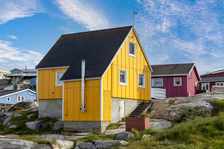 Typical architecture of Greenland Ilulissat with colored houses located near fjords and icebergs.の写真素材