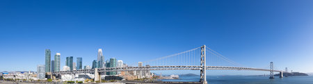 Panoramic San Francisco financial district skyline in city downtown with Oakland Bay Bridge.の写真素材