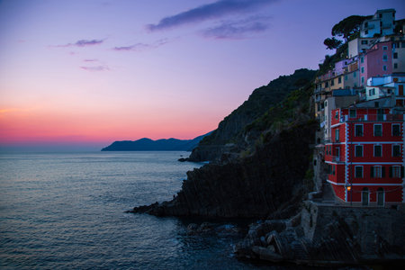Italy, Riomaggiore colorful buildings overlooking scenic shoreline. Cinque Terre landscapes in Italy.の写真素材