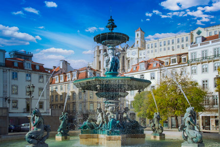 Lisbon, Rossio Square fountain and colorful historic buildings of historic city center.の写真素材