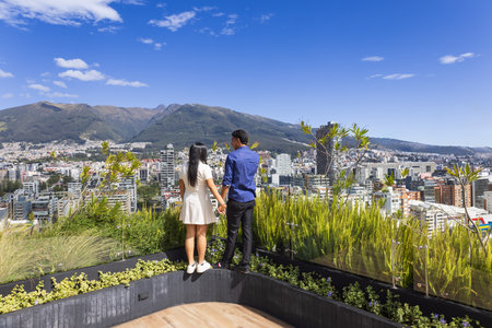 Quito, Ecuador, May 2 2025: Young tourist couple overview Carolina Park modern condominiums in Quito central business financial districtの写真素材