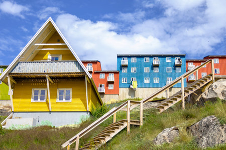 Typical architecture of Greenland city Qarqotoq with colored houses located near fjords and icebergs