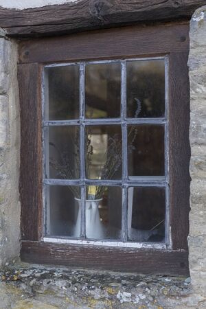 window with wooden frame on stone facade