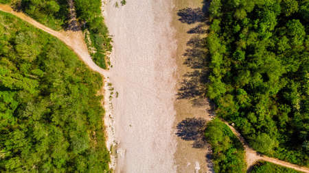 Aerial view of creek with not water and crossing road in Buttrioの写真素材