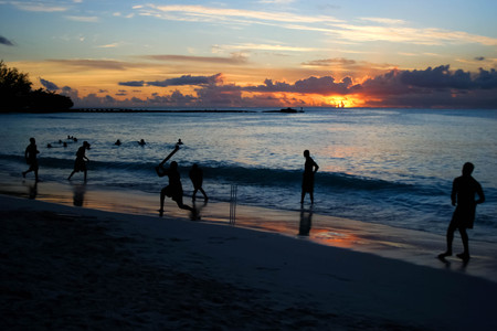 Cricket game at the beach with a beautiful sunsetの写真素材