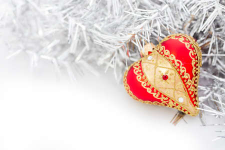 Closeup of red Christmas balls heart and on white backgroundの写真素材