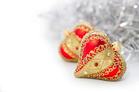 Closeup of red Christmas balls heart and on white backgroundの写真素材