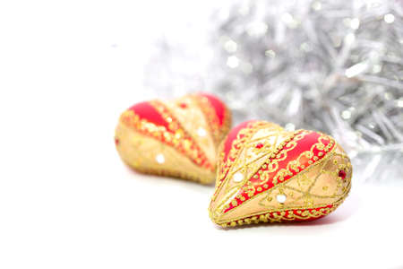Closeup of red Christmas balls heart and on white backgroundの写真素材