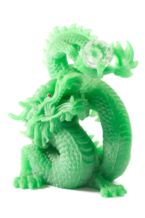 feng shui jade chinese dragon of the lucky charm sculpture isolated on white backgroundの写真素材