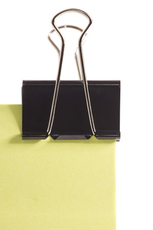 close-up black clip and green post-it note isolated on pure white backgroundの写真素材