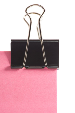 close-up black clip and pink post note isolated on pure white backgroundの写真素材