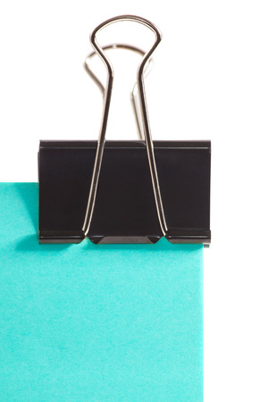 close-up black clip and blue post note isolated on pure white backgroundの写真素材