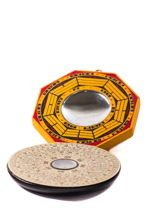 traditional feng shui mirror wood and compass isolated on pure white backgroundの写真素材