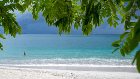 Crystal blue waters on Conchal beach in the pacific coast of Costa Rica with one man inside the...