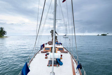 San Blas Archipelago, Panama - November 22nd, 2018: Sailing boat view from the prow of sea with...