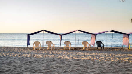 Chairs under umbrellas at the caribbean town of Rodadero, Colombia