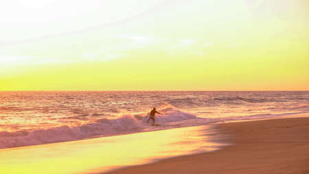 Mazunte, Oaxaca, Mexico - January, 24th, 2018: surfing at the shore during sunset at Mermejita beachのeditorial素材