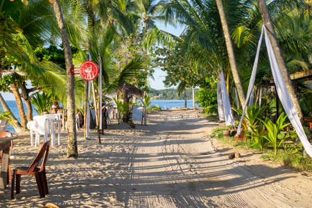 Bocas del Toro, Panama - September 11th, 2018: Main street with sand and chairs at Boca del Drago beachのeditorial素材