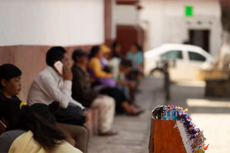 San Cristobal de las Casas, Chiapas, Mexico - March 13rd, 2018: detail of candy street vendor with people sit waitingのeditorial素材