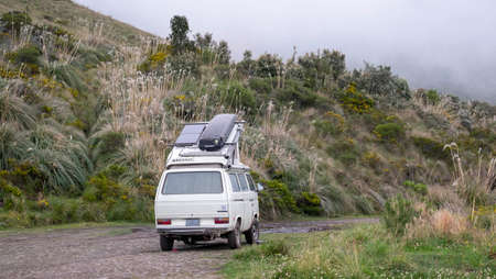 Camper van parked in a green scenery at the Mojanda Lagoon in Ecuador, February, 21st, 2019