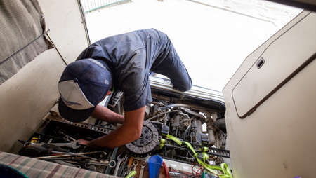 Mechanic repairs while living on the road. CHACHAPOLLAS, PERU - CIRCA MARCH 2019