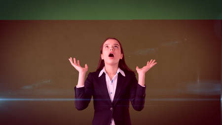 Beautiful surprised businesswoman is exclamationing splayed hands at the top with copyspase.の写真素材