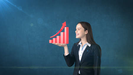 Portrait of young woman holding 3D growing chart on the open hand palm, over isolated studio background.Business conceptの写真素材