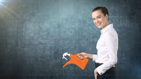 Beauty business woman watering invisible plant presenting investment and financial growth concept. Isolated backgroundの写真素材