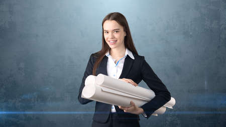 Building, developing, consrtuction and architecture concept - smiling beautiful businesswoman in...