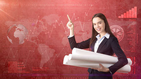 Building, developing, consrtuction and architecture concept - smiling woman in suit with blueprint...