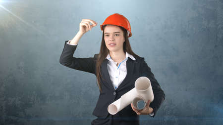 Building, developing, consrtuction and architecture concept - smiling businesswoman in orange helmet...