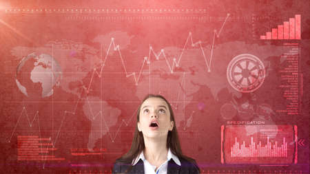 Beautiful businesswoman looking up at copyspace. Standing over business and investmen concept background.の写真素材