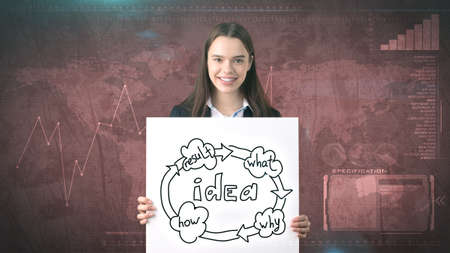 Creative ideas concept, businesswoman standing on studio painted background holding paper with organizational chart.の写真素材