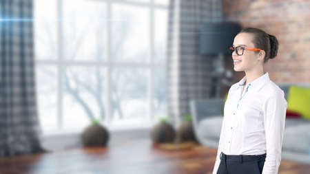 Young beautiful business woman and creative designer standing over blured interior backgroundの写真素材