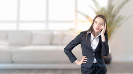 Young beautiful business woman and creative designer standing over blured interior backgroundの写真素材