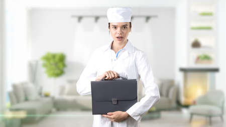 Beautiful medical woman doctor in uniform. Studio painted background. Concept of profitable health care.の写真素材